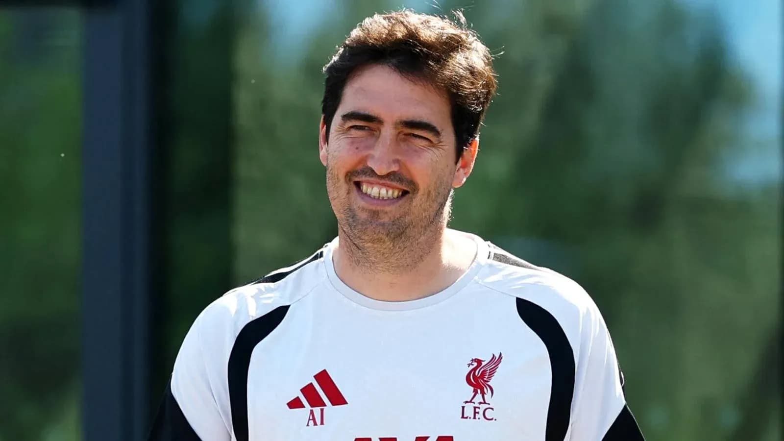 Coach smiling during Liverpool training session