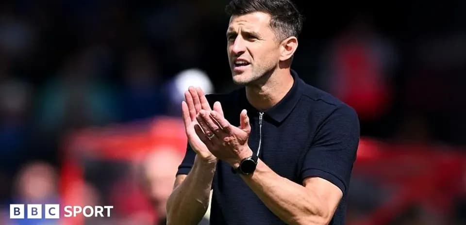 Coach applauding during a match on the sidelines