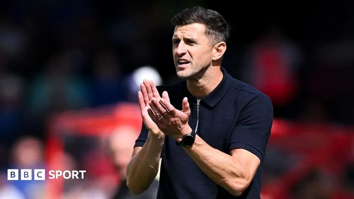 Coach applauding during a match on the sidelines