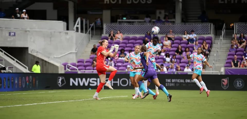 Goalkeeper saving ball during NWSL match
