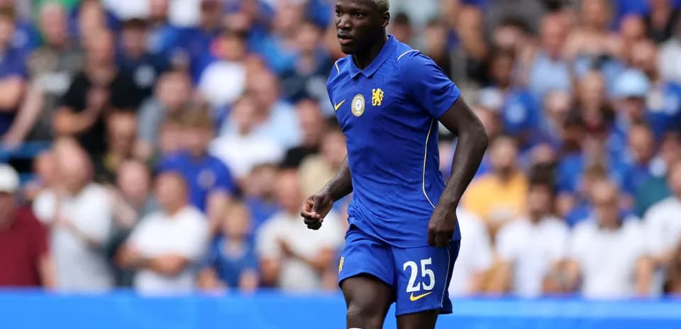 Player in blue Chelsea kit running on the pitch