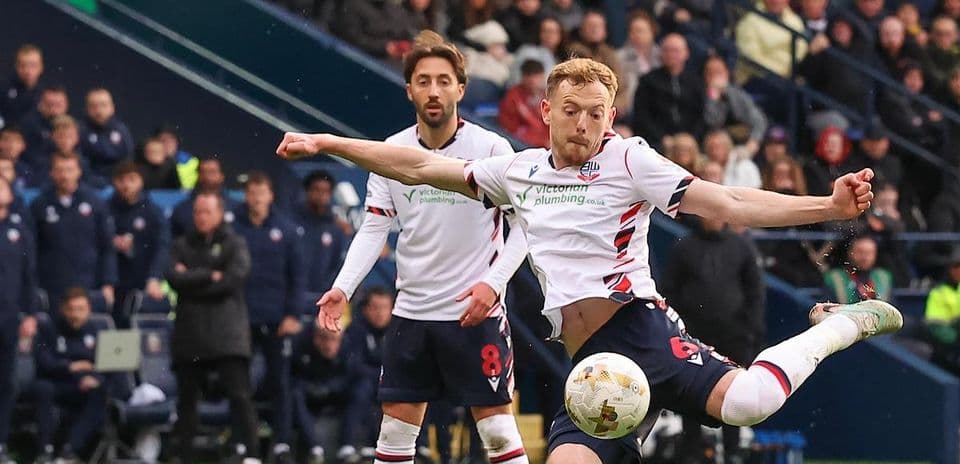 Bolton player striking the ball during match