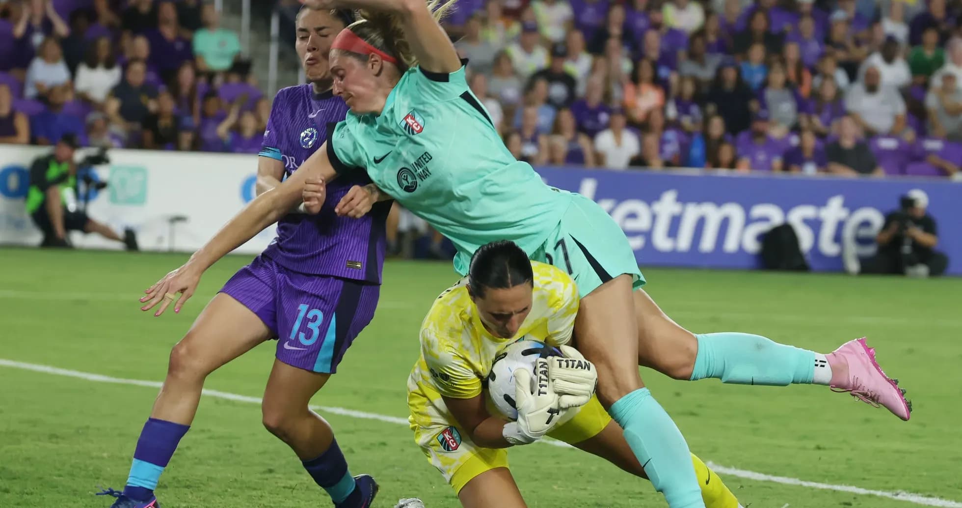Players competing for the ball during NWSL match