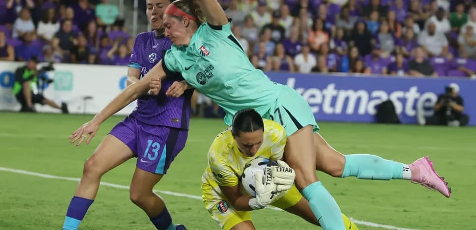 Players competing for the ball during NWSL match
