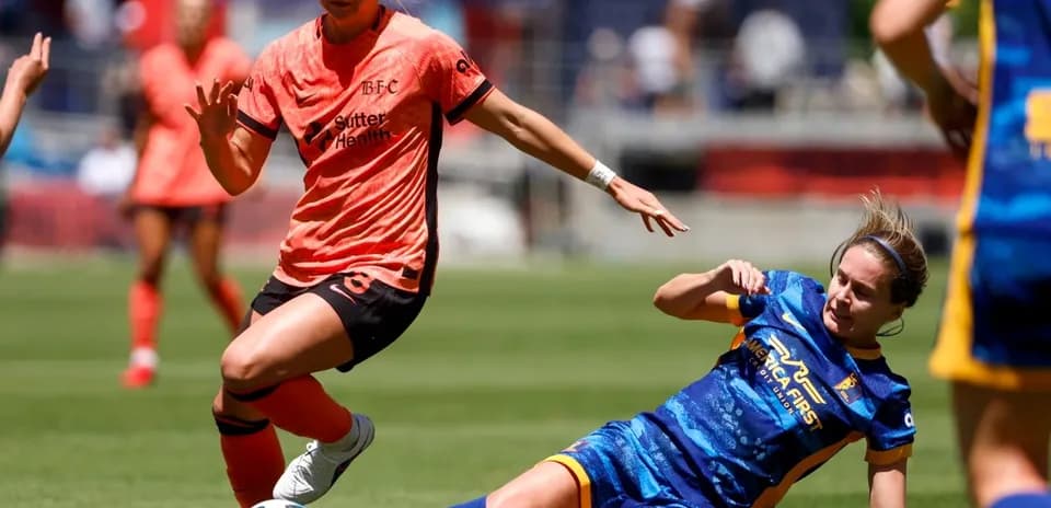 Bay FC player challenging Utah Royals opponent