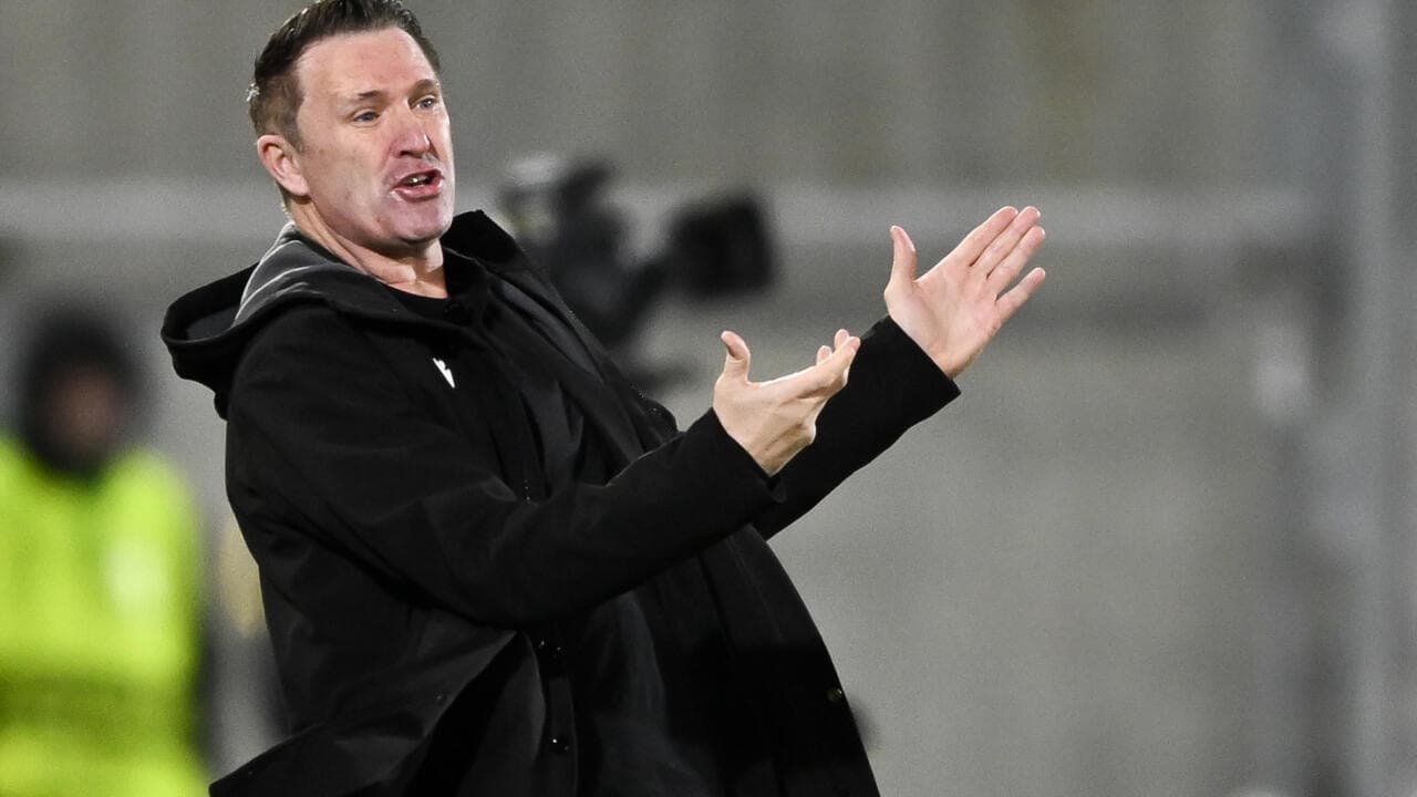 Coach gesturing during match from the sidelines