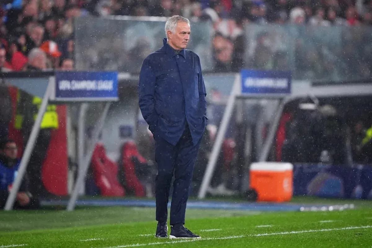 Manager observing match in rainy conditions
