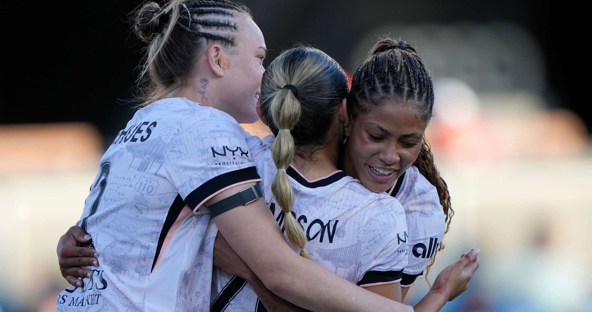 Players celebrating during Angel City match