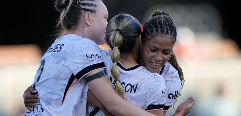 Players celebrating during Angel City match