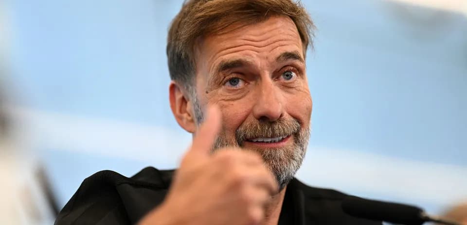 Manager giving thumbs up at press conference
