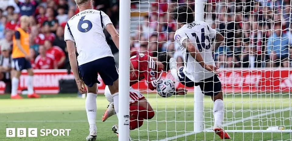 Player attempting to score as goalkeeper defends goal