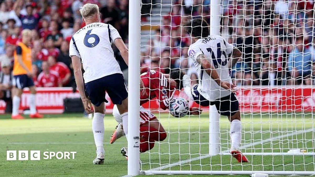 Player attempting to score as goalkeeper defends goal
