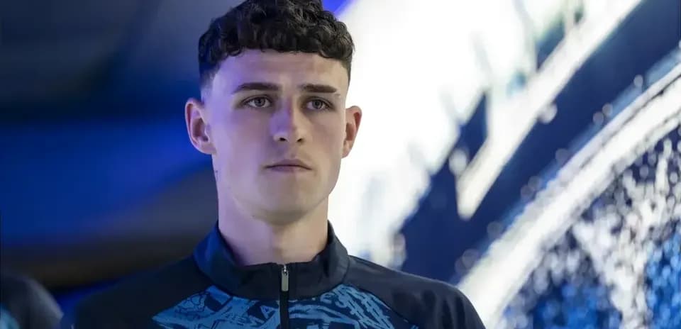 Player in Manchester City training gear, focused expression