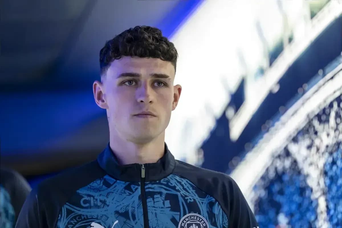 Player in Manchester City training gear, focused expression
