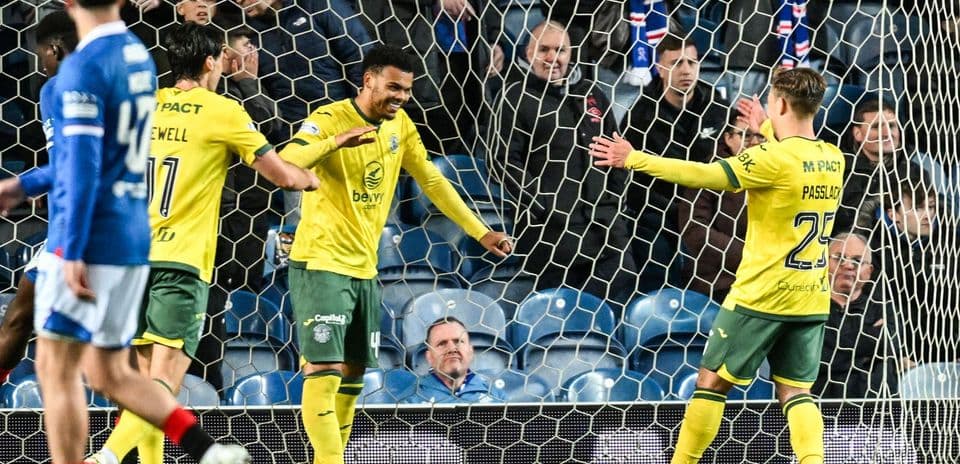 Players celebrating a goal in front of fans