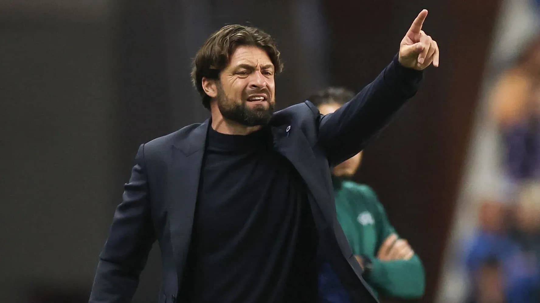 Coach directing players during a match