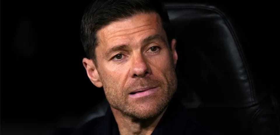 Coach seated on bench during match
