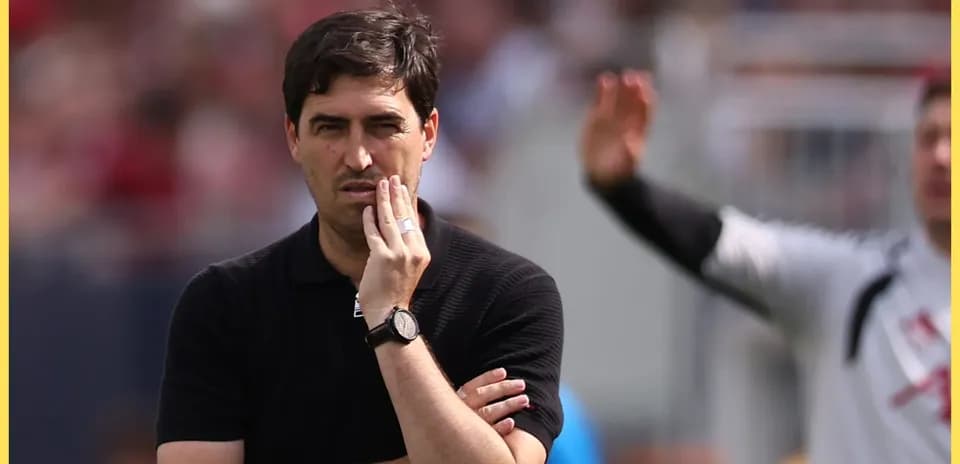 Coach observing the match with thoughtful expression