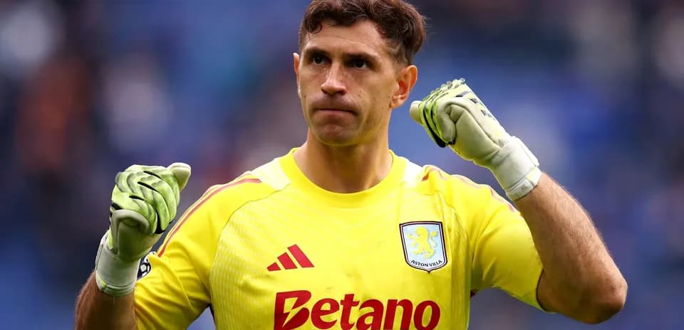 Goalkeeper celebrating in yellow kit with gloves