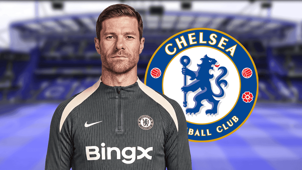 Chelsea FC coach posing with club logo backdrop