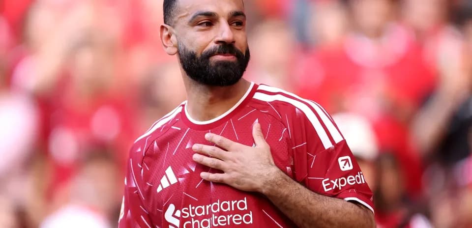 Player wearing red jersey gestures to crowd