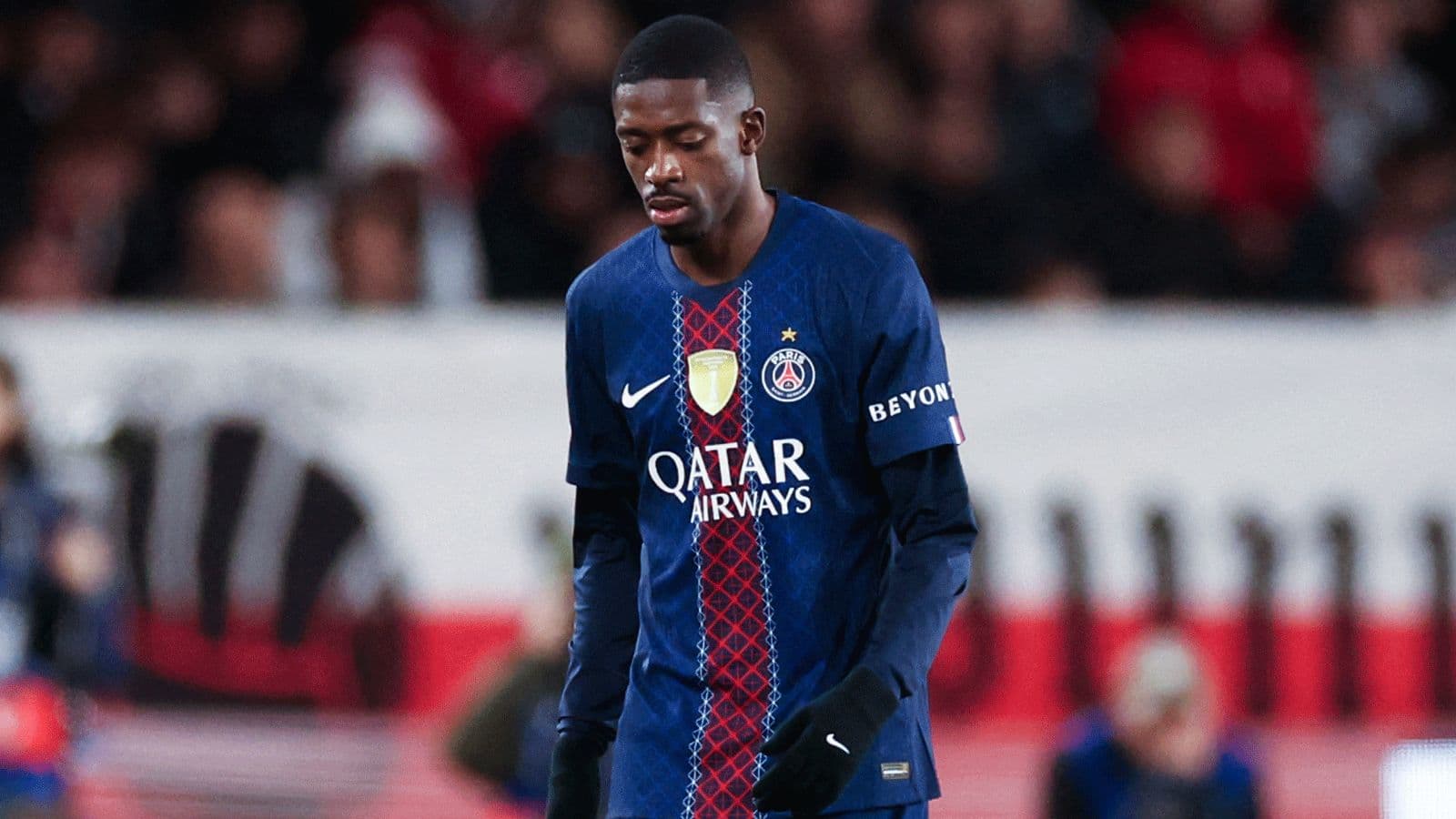 Player in PSG kit walking on the pitch