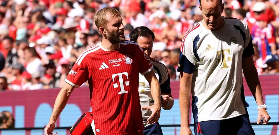 Bayern Munich player leaving field with medical staff