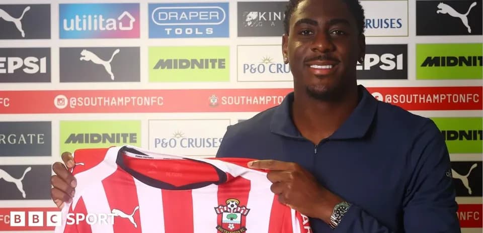 Player holding Southampton FC jersey at press conference