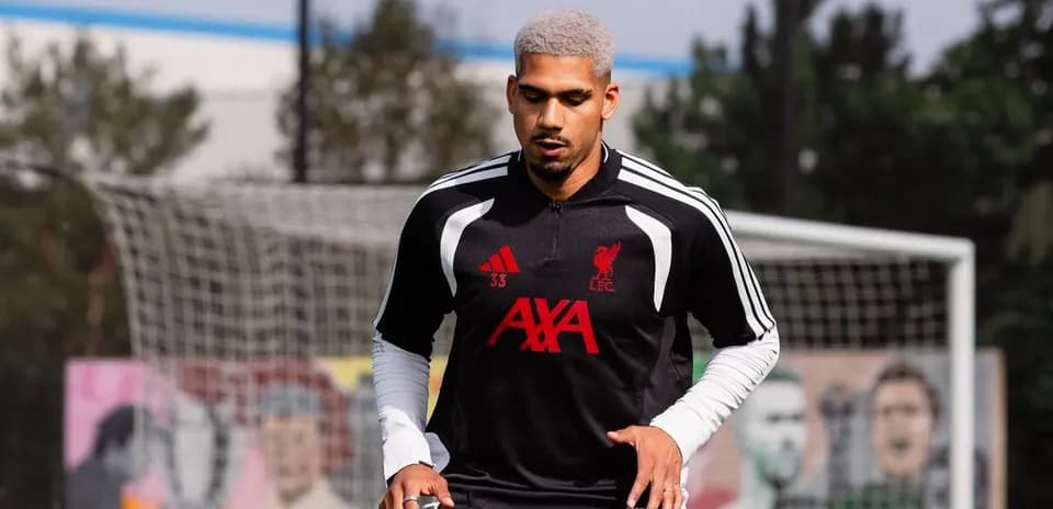 Player training in Liverpool FC kit on pitch