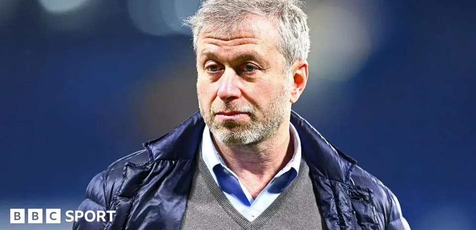 Man with gray hair wearing a jacket and sweater
