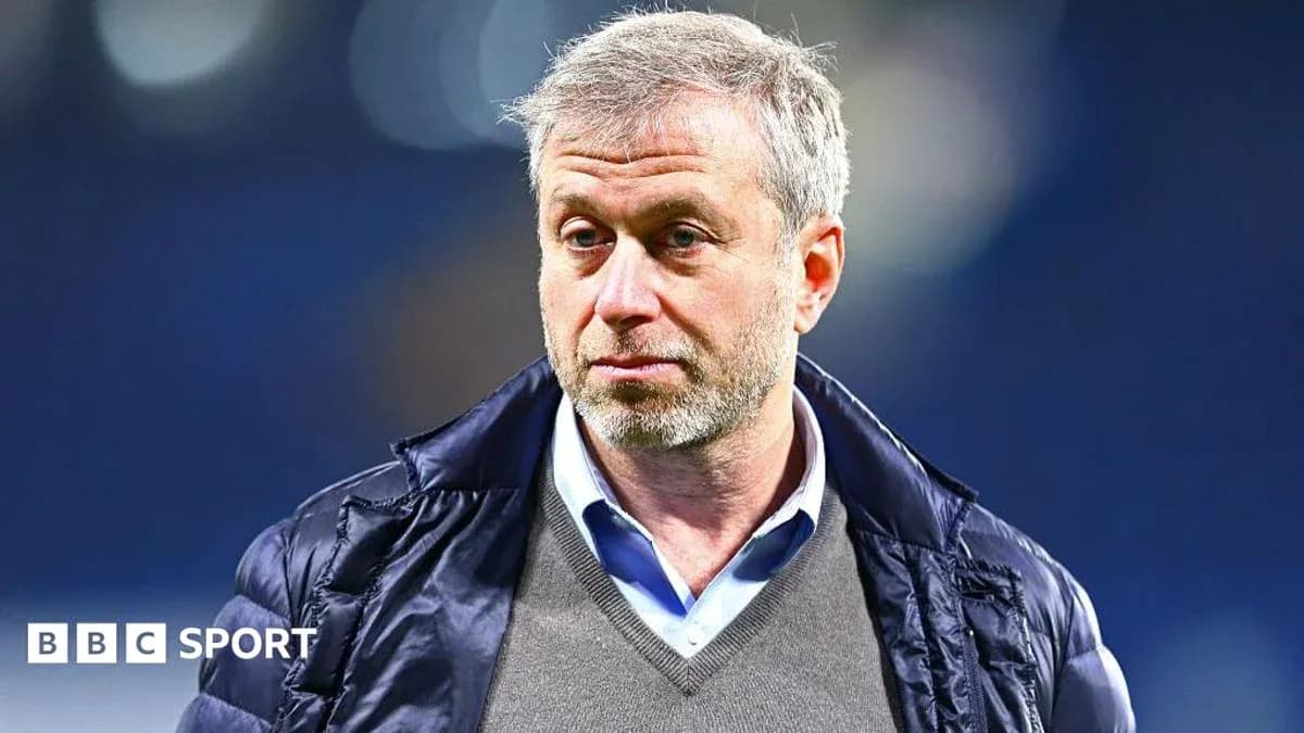 Man with gray hair wearing a jacket and sweater