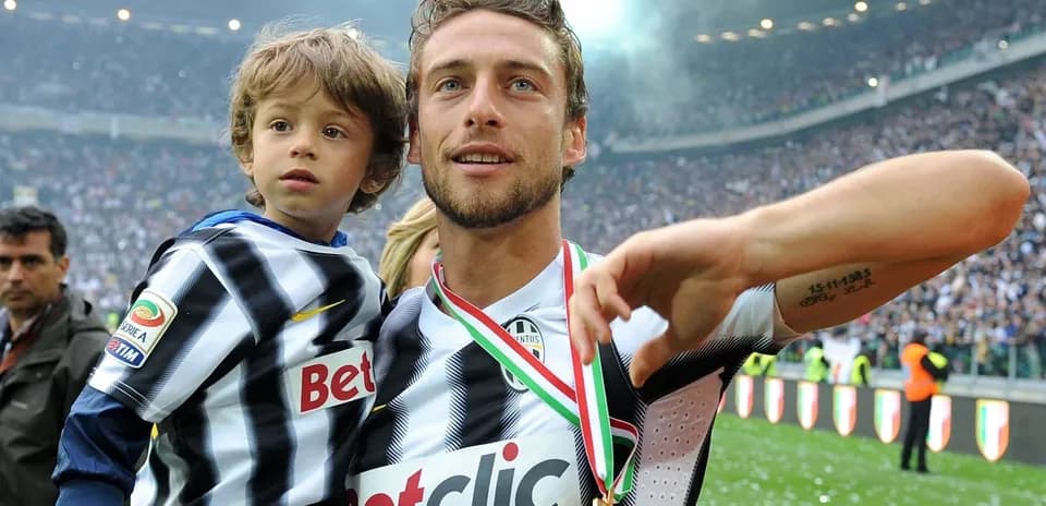 Player celebrating with child on the field