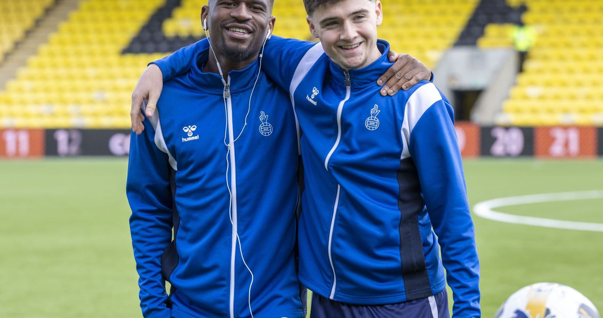 Two players posing together on the football pitch