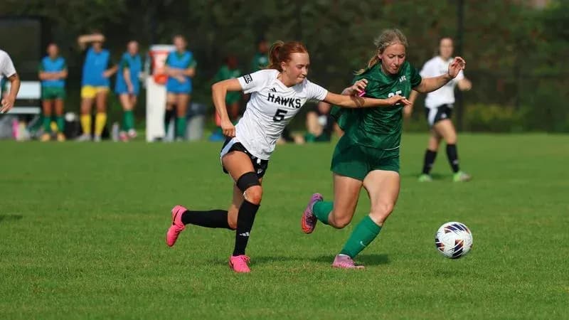 Two players contesting the ball during soccer match