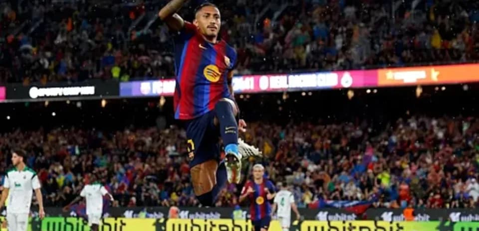 Player celebrating a goal at FC Barcelona stadium