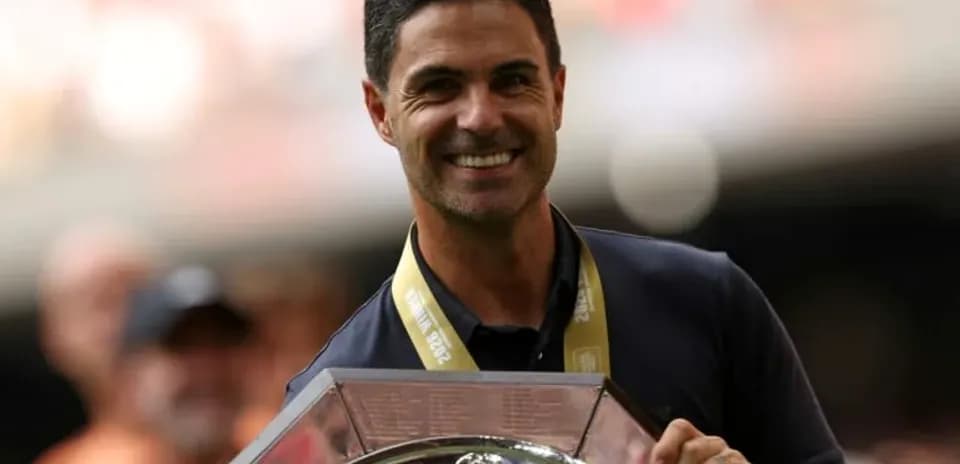 Coach holding trophy during victory celebration