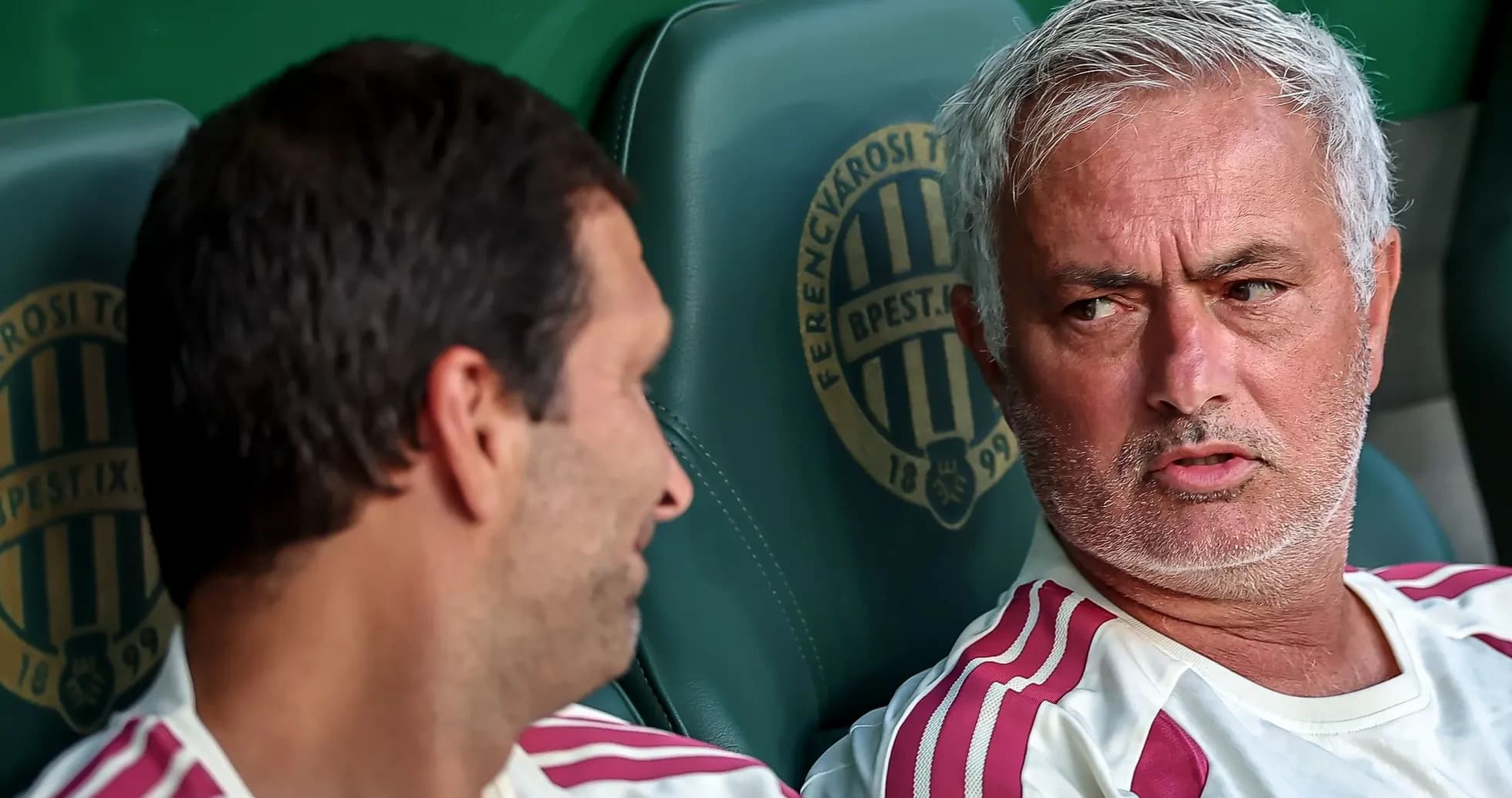 Coaches discussing on the bench during a match