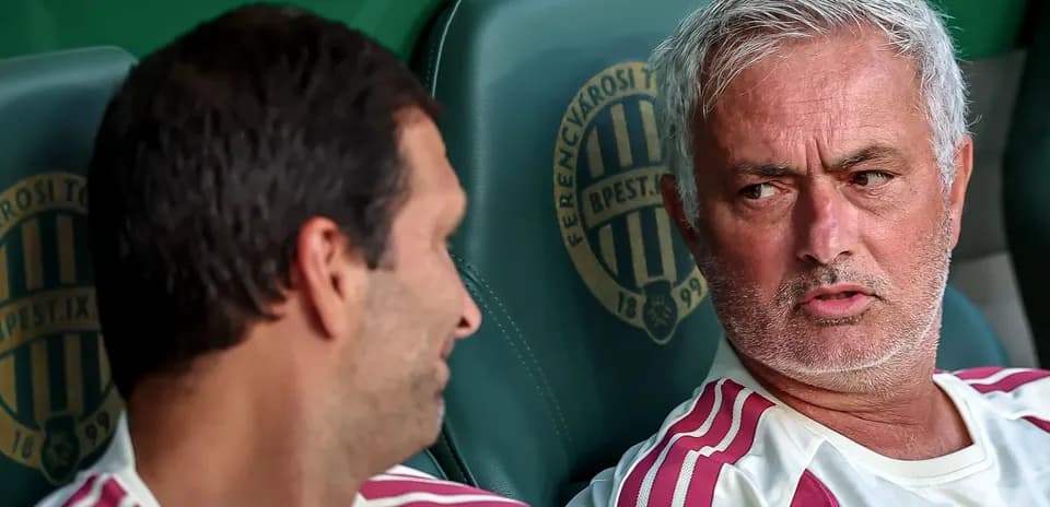 Coaches discussing on the bench during a match