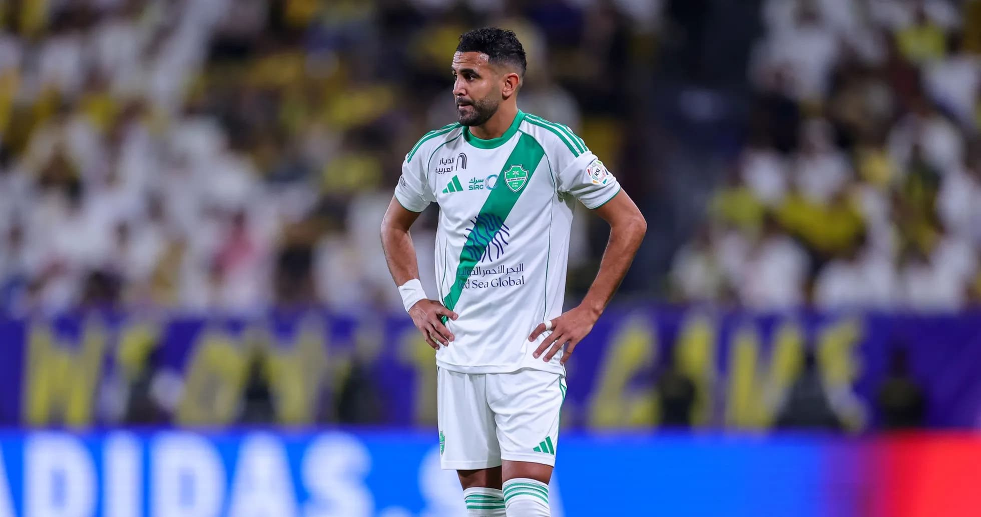 Player standing with hands on hips during match