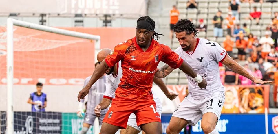 Vancouver FC player battling for the ball