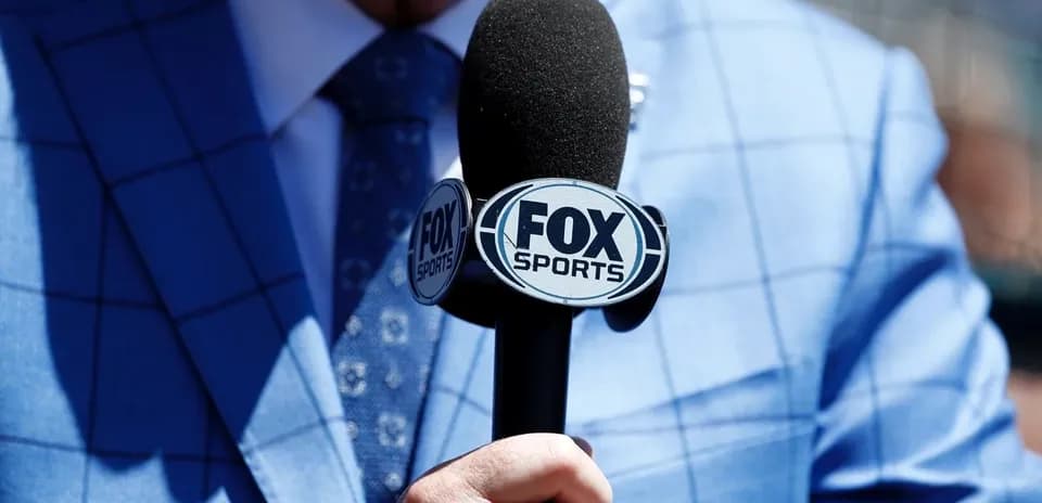 Microphone with FOX Sports logo held by a person