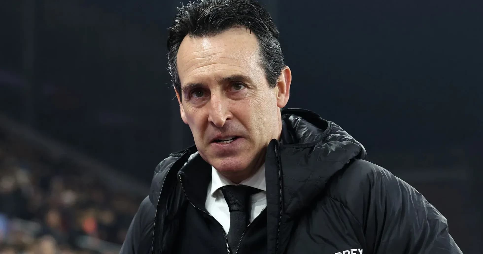 Football manager speaking on the sidelines during match