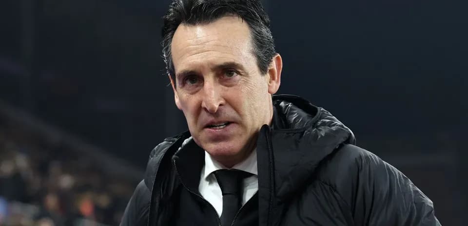 Football manager speaking on the sidelines during match