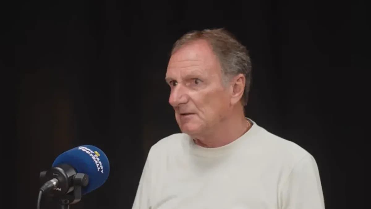 Person speaking at a microphone during interview