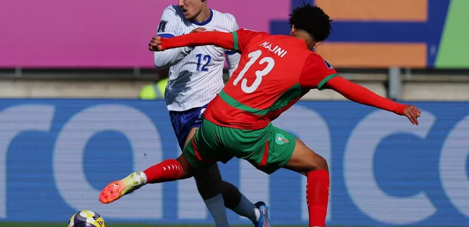 Player tackling opponent during football match