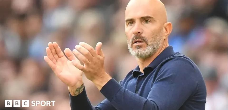 Coach applauding during a match on the sidelines