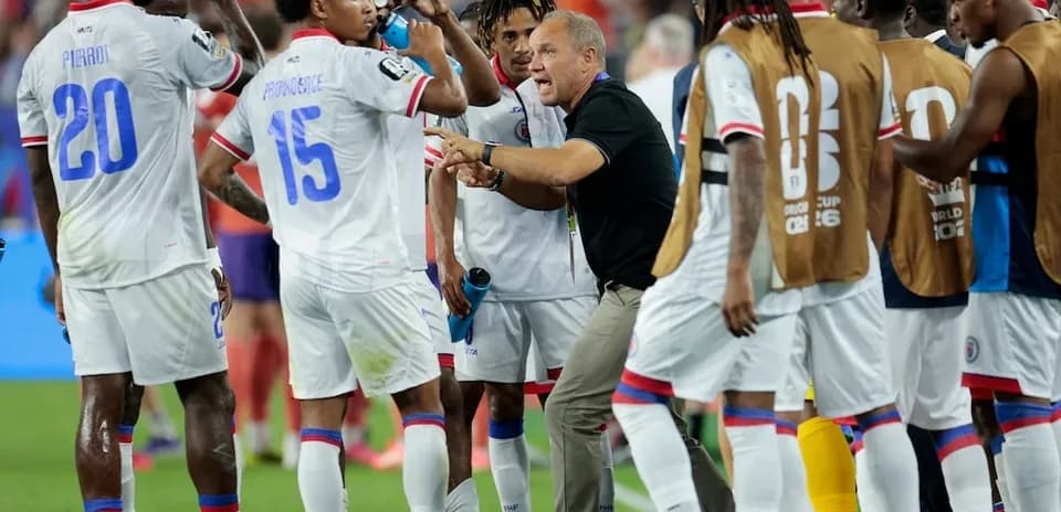 Haiti team discussing strategy during match