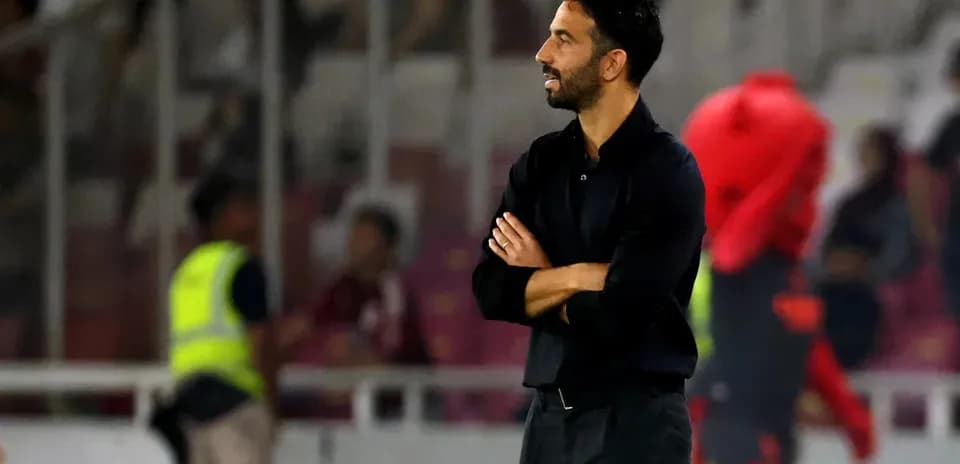 Coach observing match from the sidelines