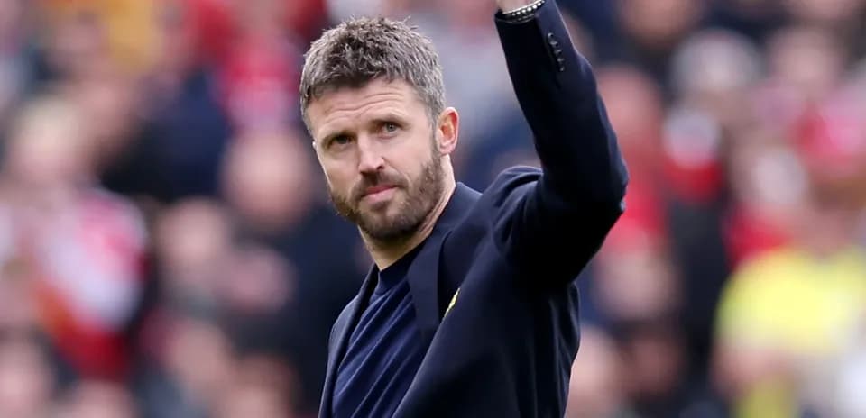 Coach waving to crowd during a match