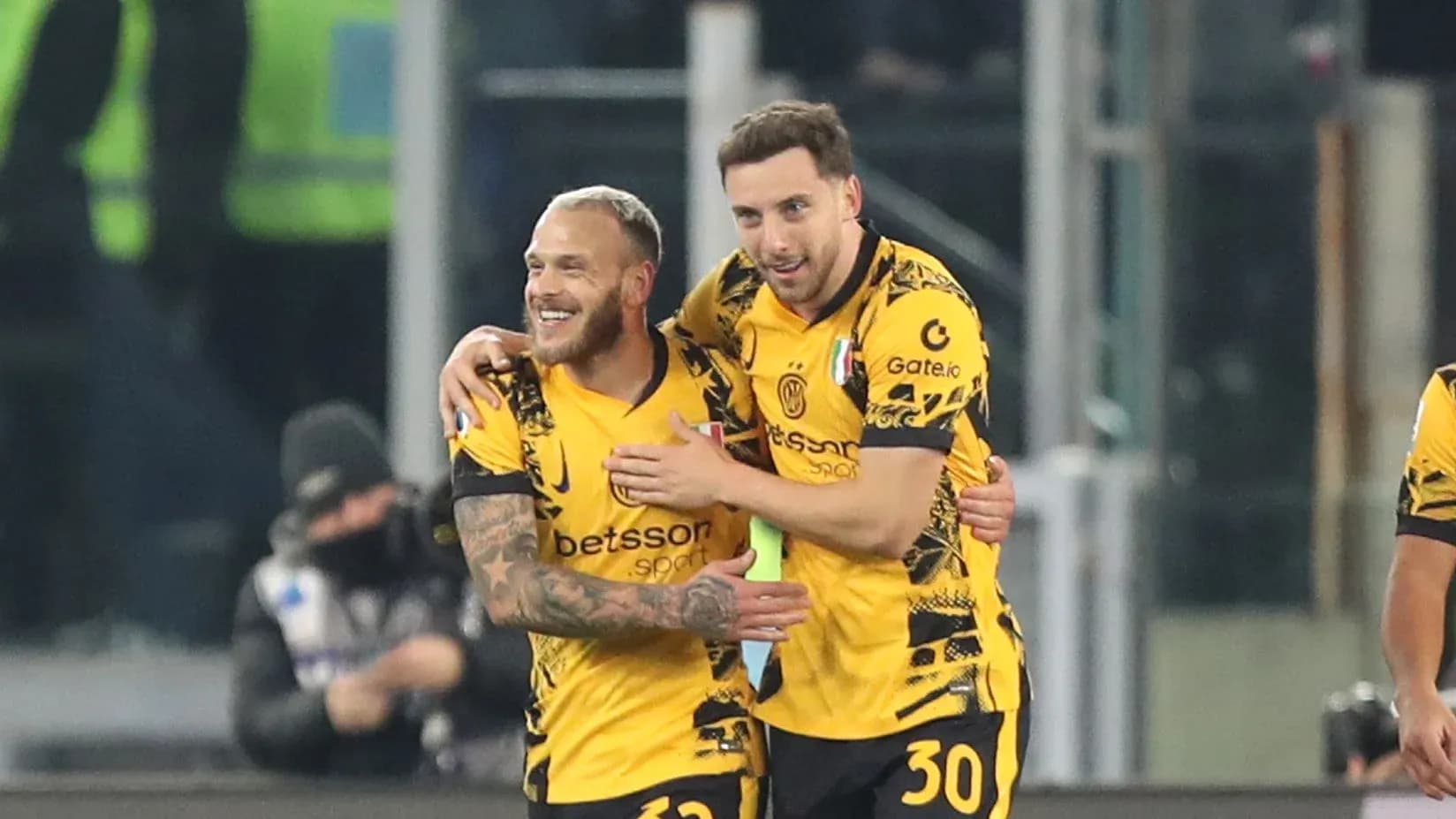 Two players celebrating a goal on the field